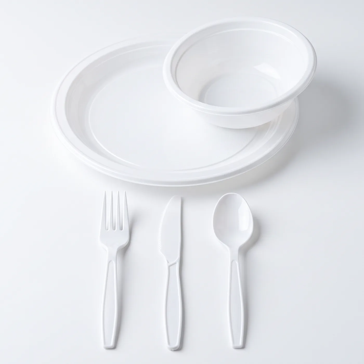 White plate, bowl, fork, knife and spoon